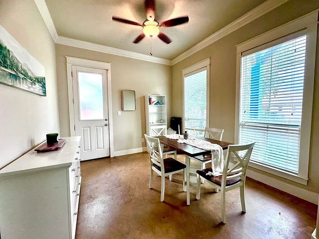 4420 Red River Street, Unit B Austin, TX 78751 - Photo 4 of 11 Functional dining space featuring a ceiling fan and abundant natural light.
