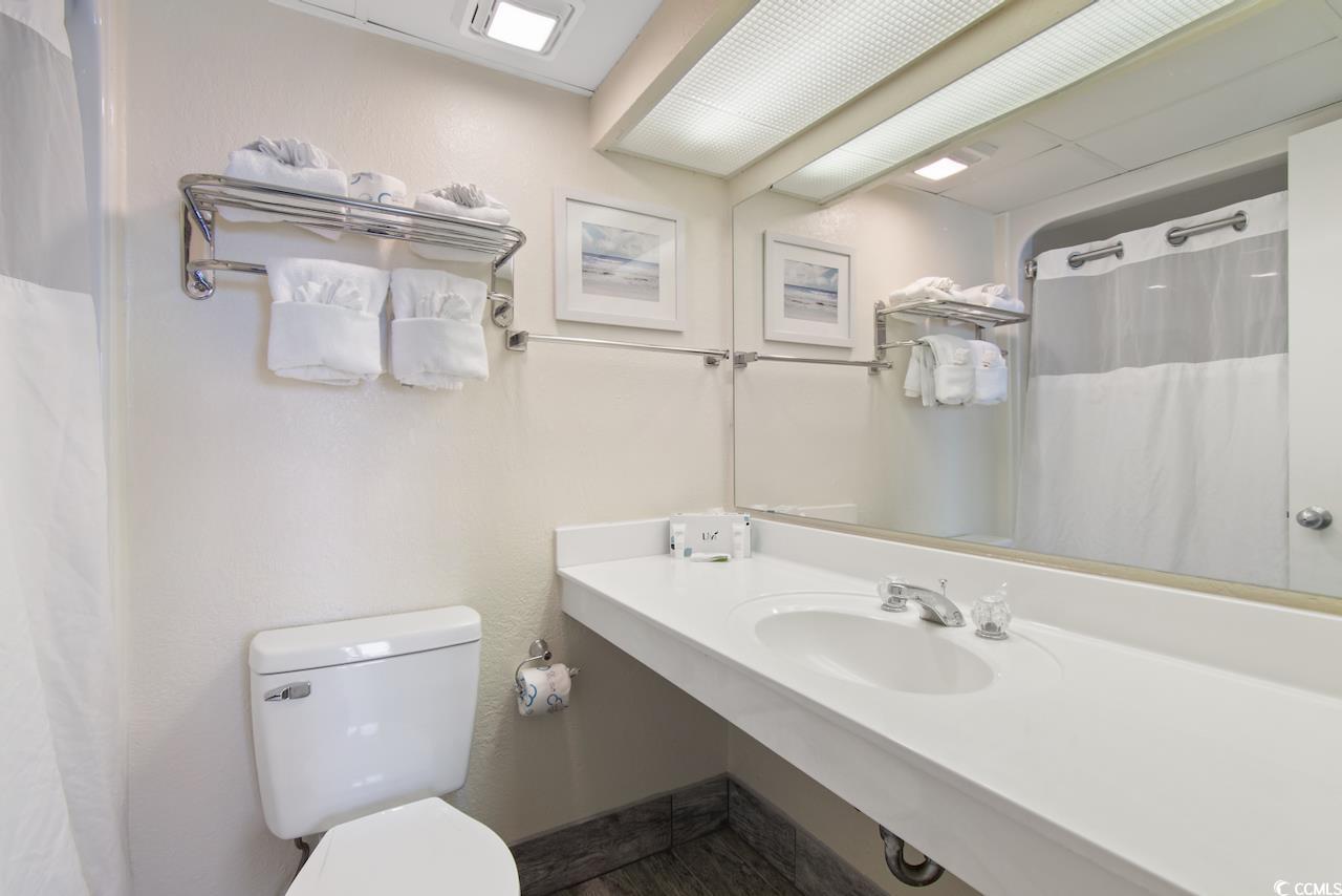 2300 North Ocean Boulevard, Unit 830 Myrtle Beach, SC 29577 - Photo 20 of 33 Bathroom with toilet and a shower with curtain