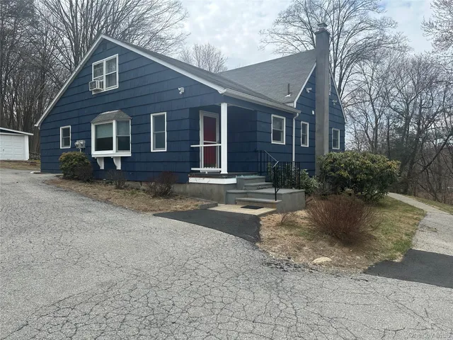 a view of a house with a yard covered with snow