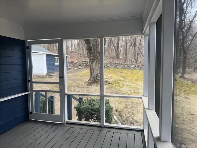 a view of a room with wooden floor and windows