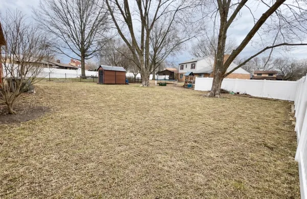 a view of a house with wooden fence