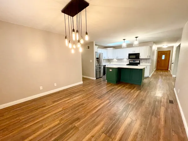 a view of kitchen with sink and wooden floor