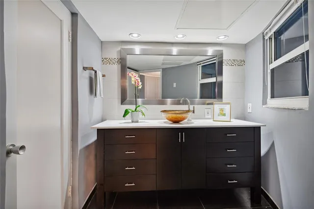 a bathroom with a sink double vanity and a mirror