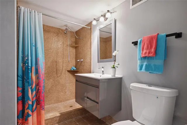 a bathroom with a sink toilet and shower