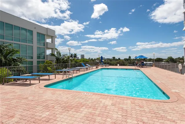 a view of a swimming pool with a lounge chairs