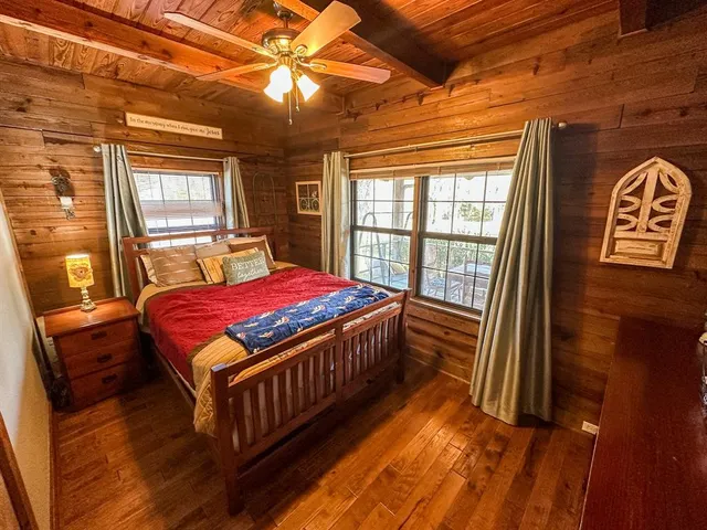 a bedroom with a bed next to a window