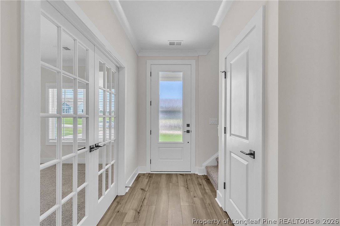 85 Camp Rock Road Lillington, NC 27546 - Photo 3 of 20 a view of a hallway with wooden floor and entryway