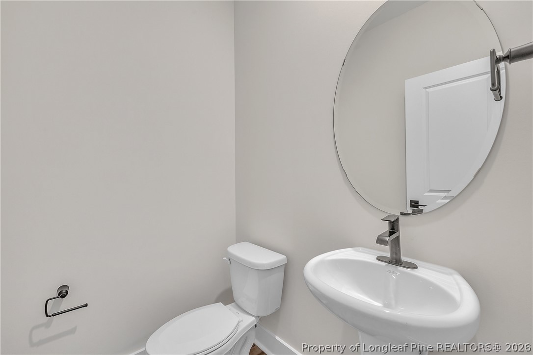 85 Camp Rock Road Lillington, NC 27546 - Photo 4 of 20 a bathroom with a sink mirror and toilet