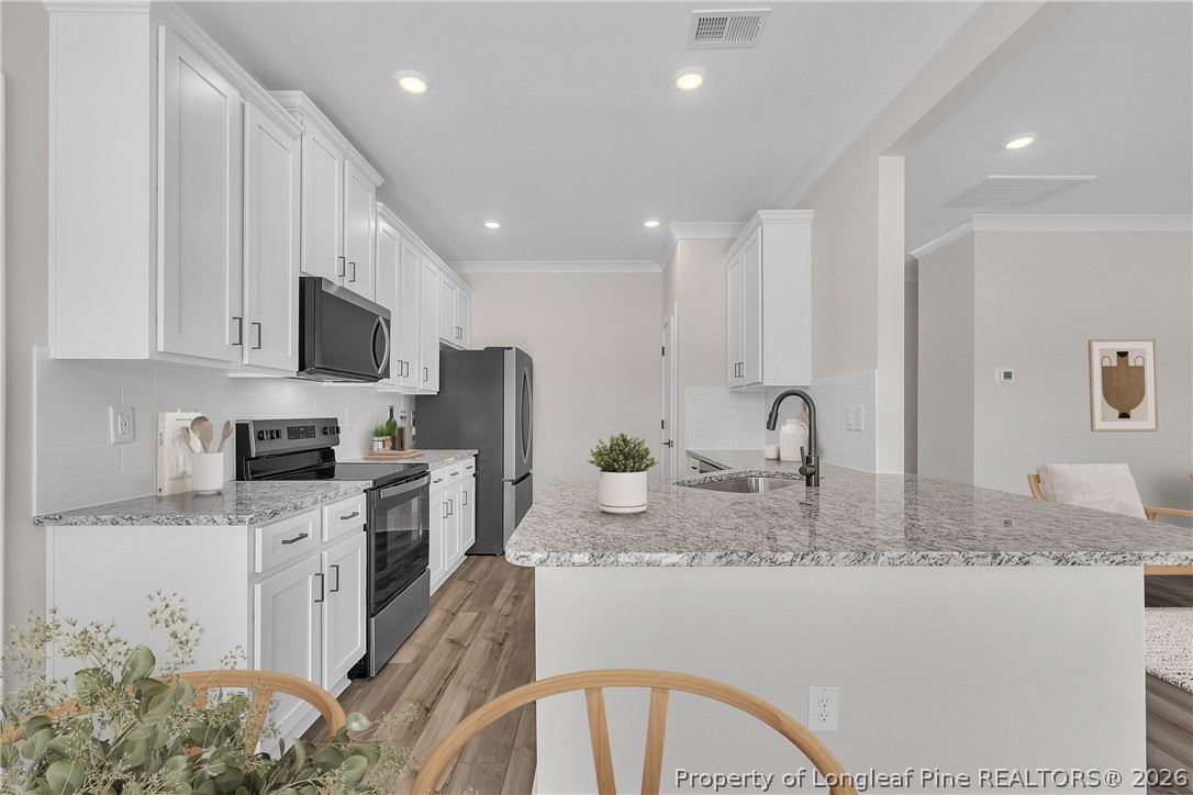 85 Camp Rock Road Lillington, NC 27546 - Photo 7 of 20 a kitchen with sink a stove and cabinets