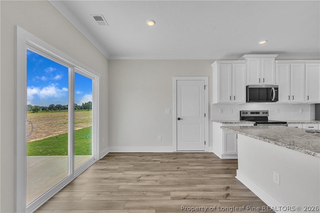 85 Camp Rock Road Lillington, NC 27546 - Photo 9 of 20 a view of a kitchen with microwave and cabinets