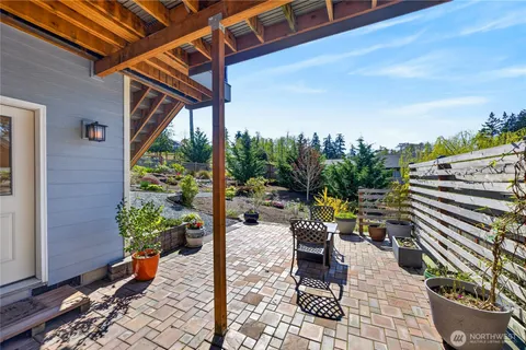 a view of a patio with a table and chairs and potted plants