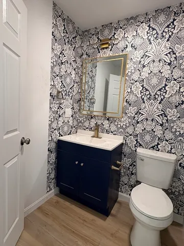 a bathroom with a sink toilet and mirror