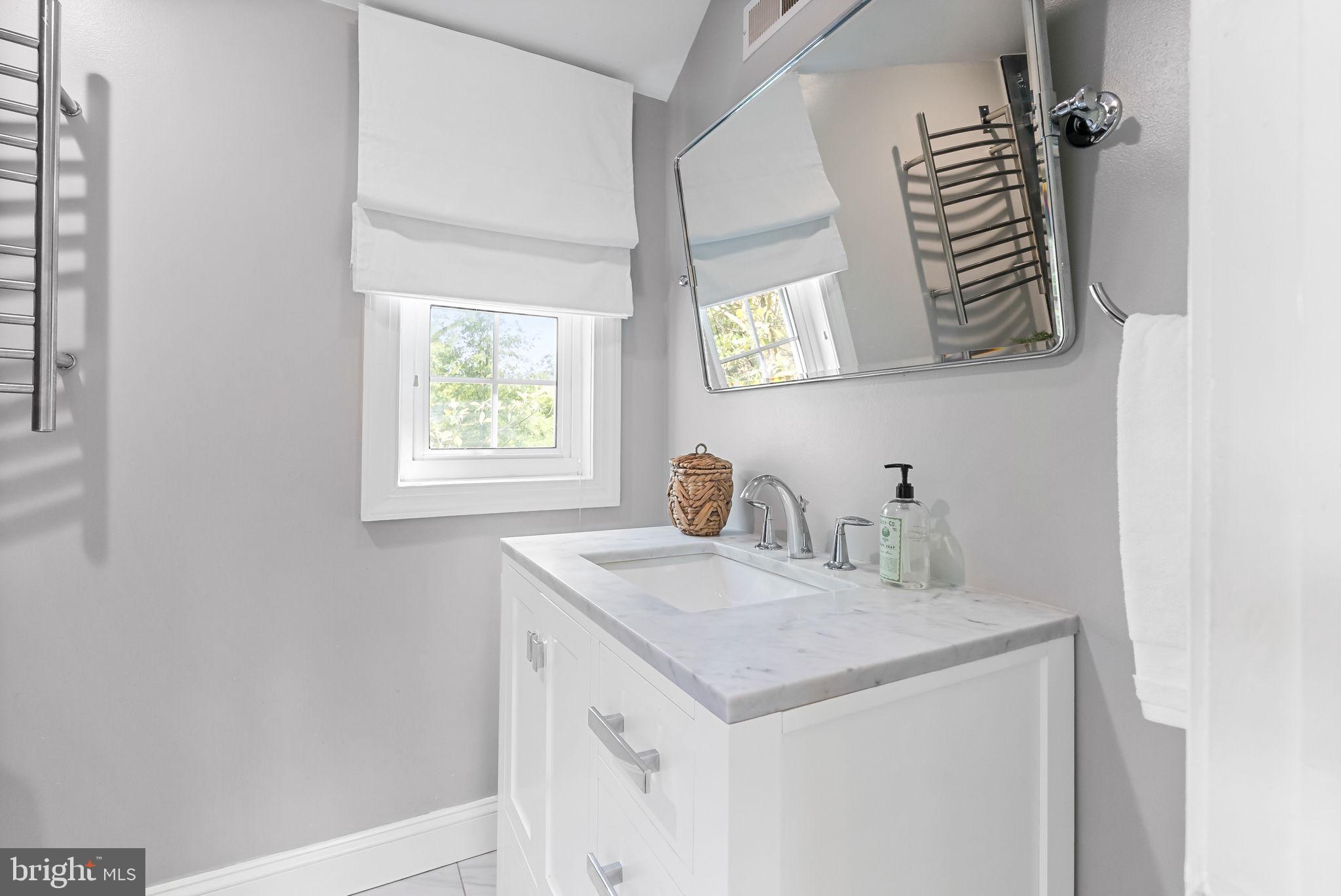 810 Grand View Drive Alexandria, VA 22305 - Photo 17 of 55 a bathroom with a sink and a mirror