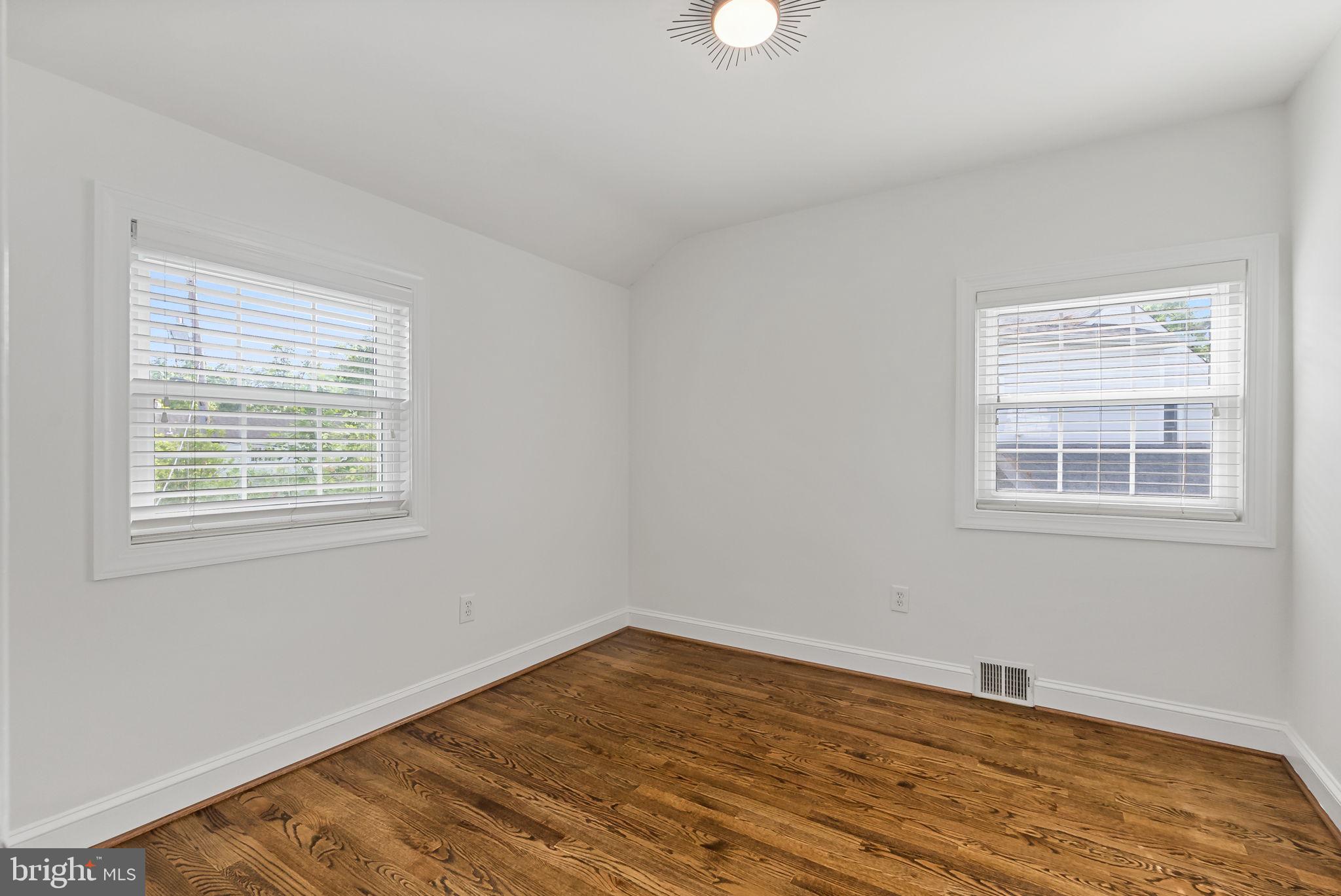 810 Grand View Drive Alexandria, VA 22305 - Photo 21 of 55 a view of empty room with wooden floor and fan