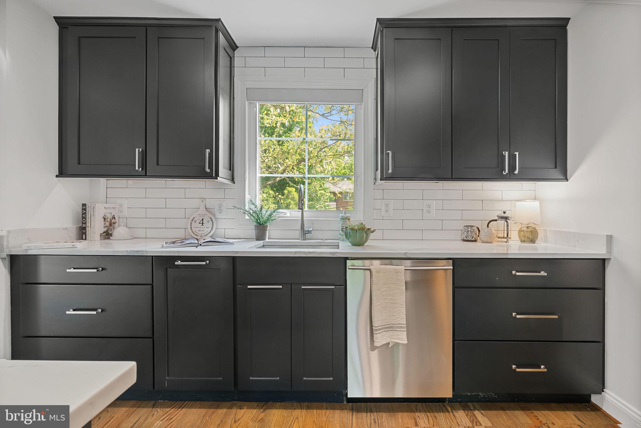 810 Grand View Drive Alexandria, VA 22305 - Photo 41 of 55 a kitchen with a sink cabinets and a window