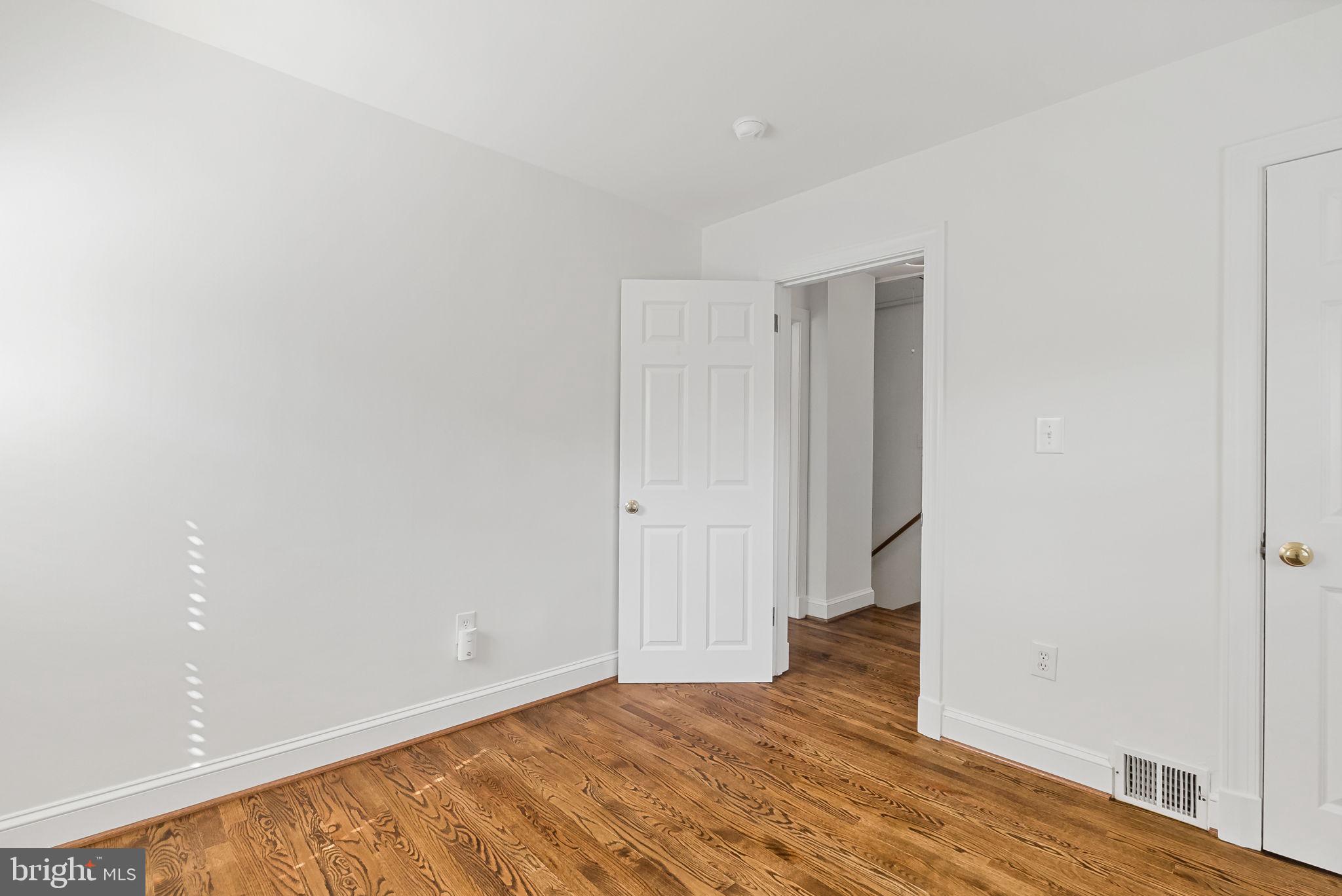810 Grand View Drive Alexandria, VA 22305 - Photo 47 of 55 a view of an empty room with wooden floor and closet