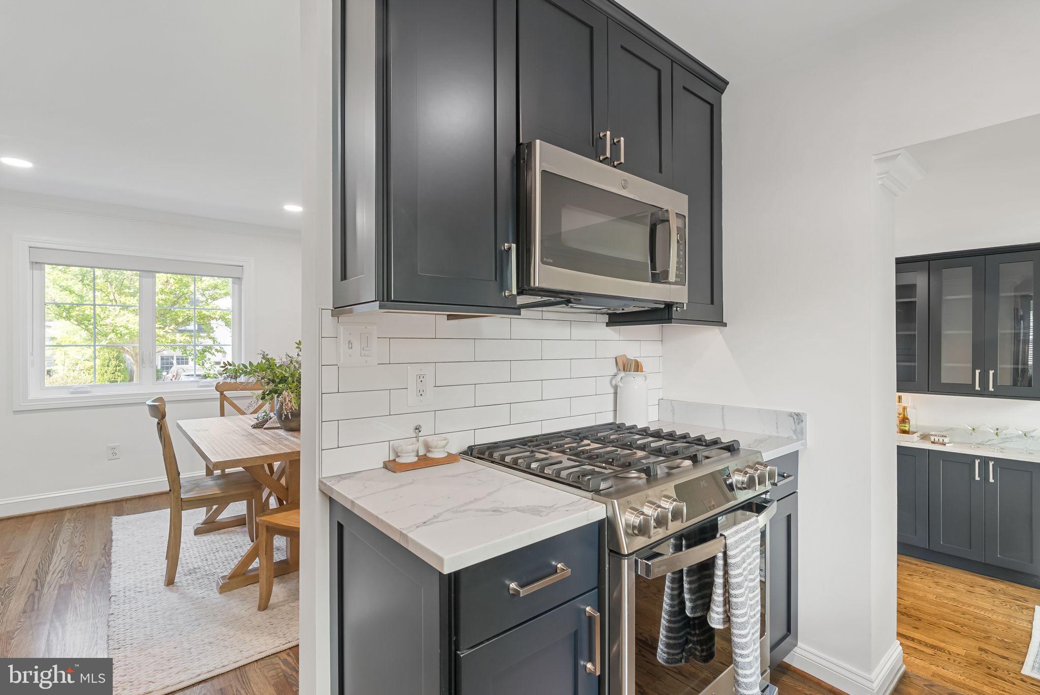 810 Grand View Drive Alexandria, VA 22305 - Photo 7 of 55 a kitchen with a stove a sink and a microwave