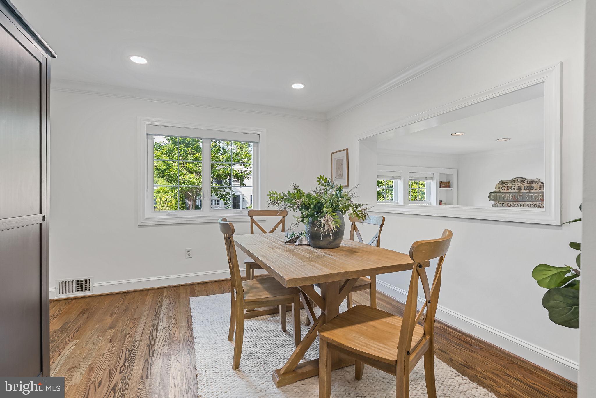 810 Grand View Drive Alexandria, VA 22305 - Photo 8 of 55 a view of a dining room with furniture and a potted plant