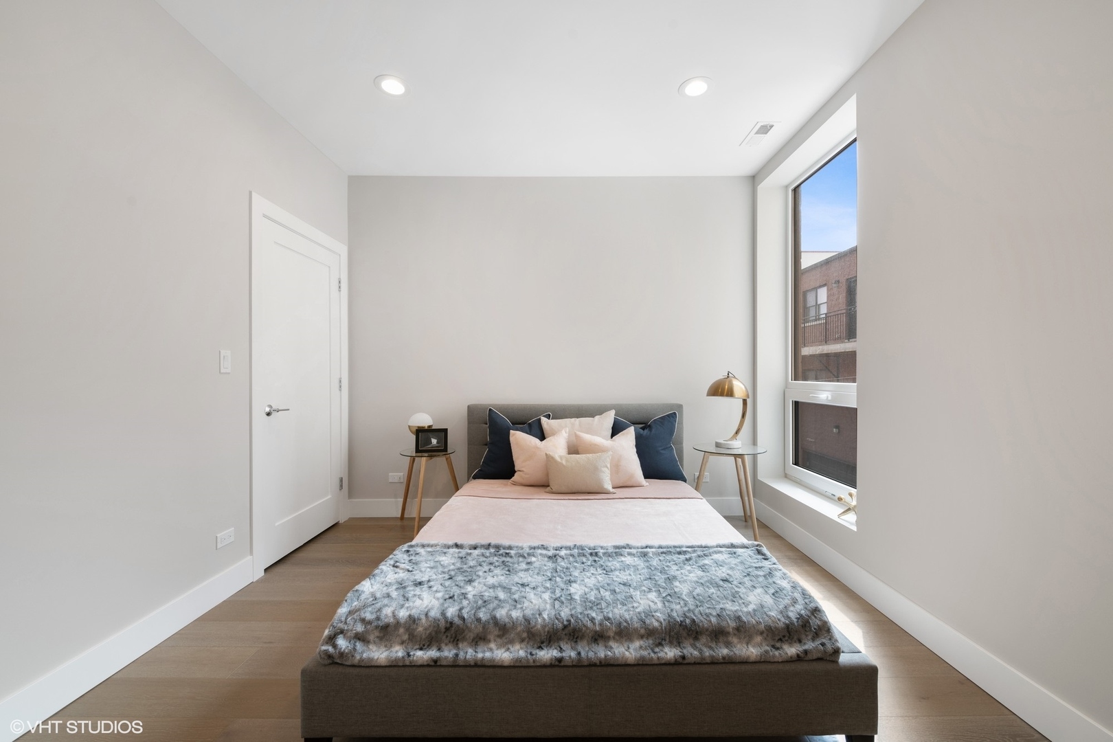 2342 West Adams Street, Unit 505 Chicago, IL 60612 - Photo 12 of 20 a bedroom with a large bed and a window