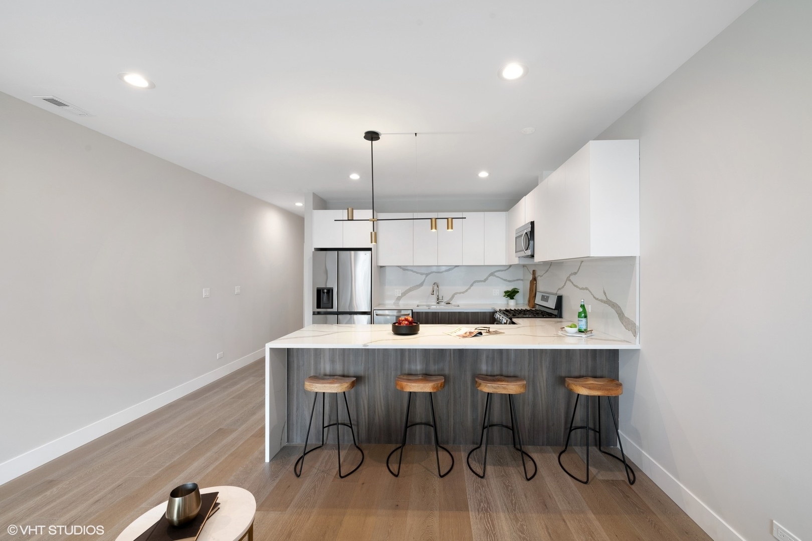 2342 West Adams Street, Unit 505 Chicago, IL 60612 - Photo 3 of 20 a kitchen with a table chairs microwave and cabinets