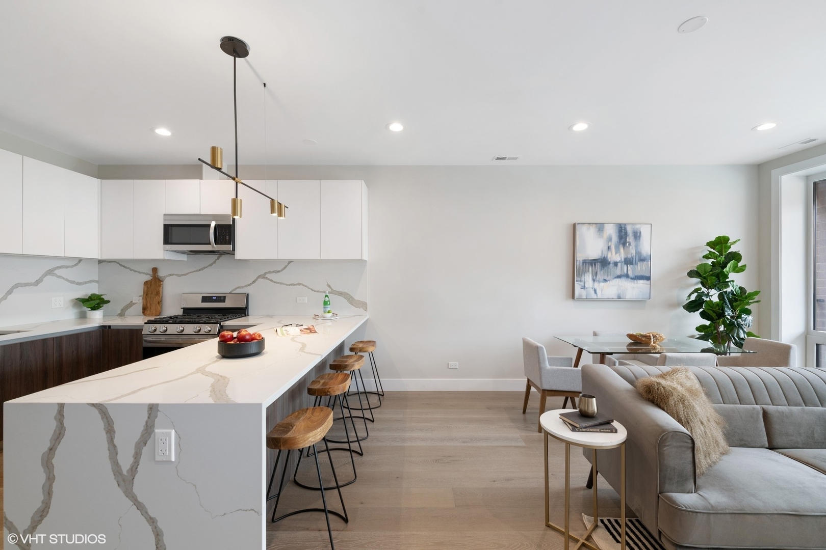 2342 West Adams Street, Unit 505 Chicago, IL 60612 - Photo 10 of 20 a kitchen with stainless steel appliances a stove a refrigerator a sink a couch and white cabinets