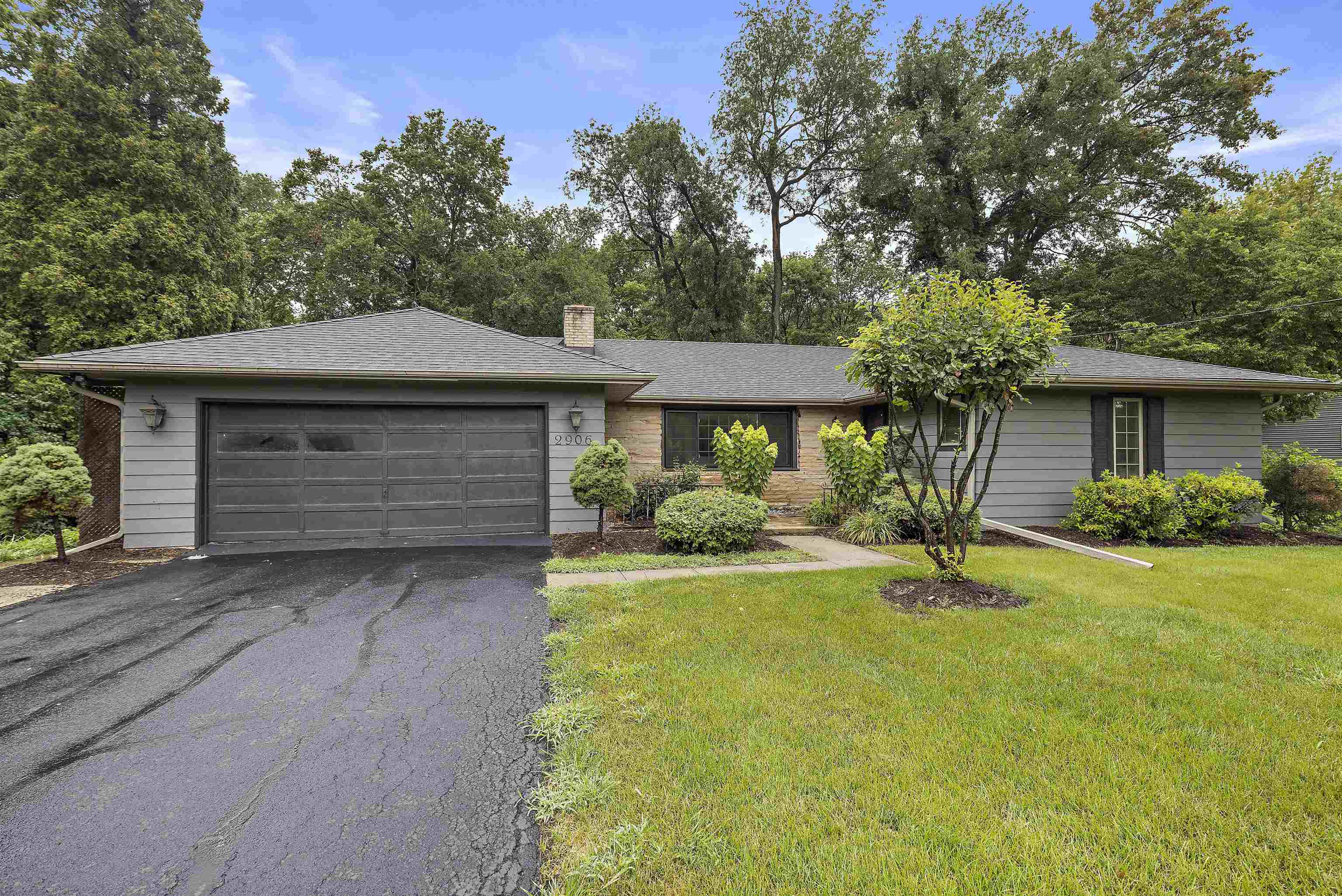 2906 Reid Farm Road Rockford, IL 61114 - Photo 2 of 18 a front view of a house with a yard and garage