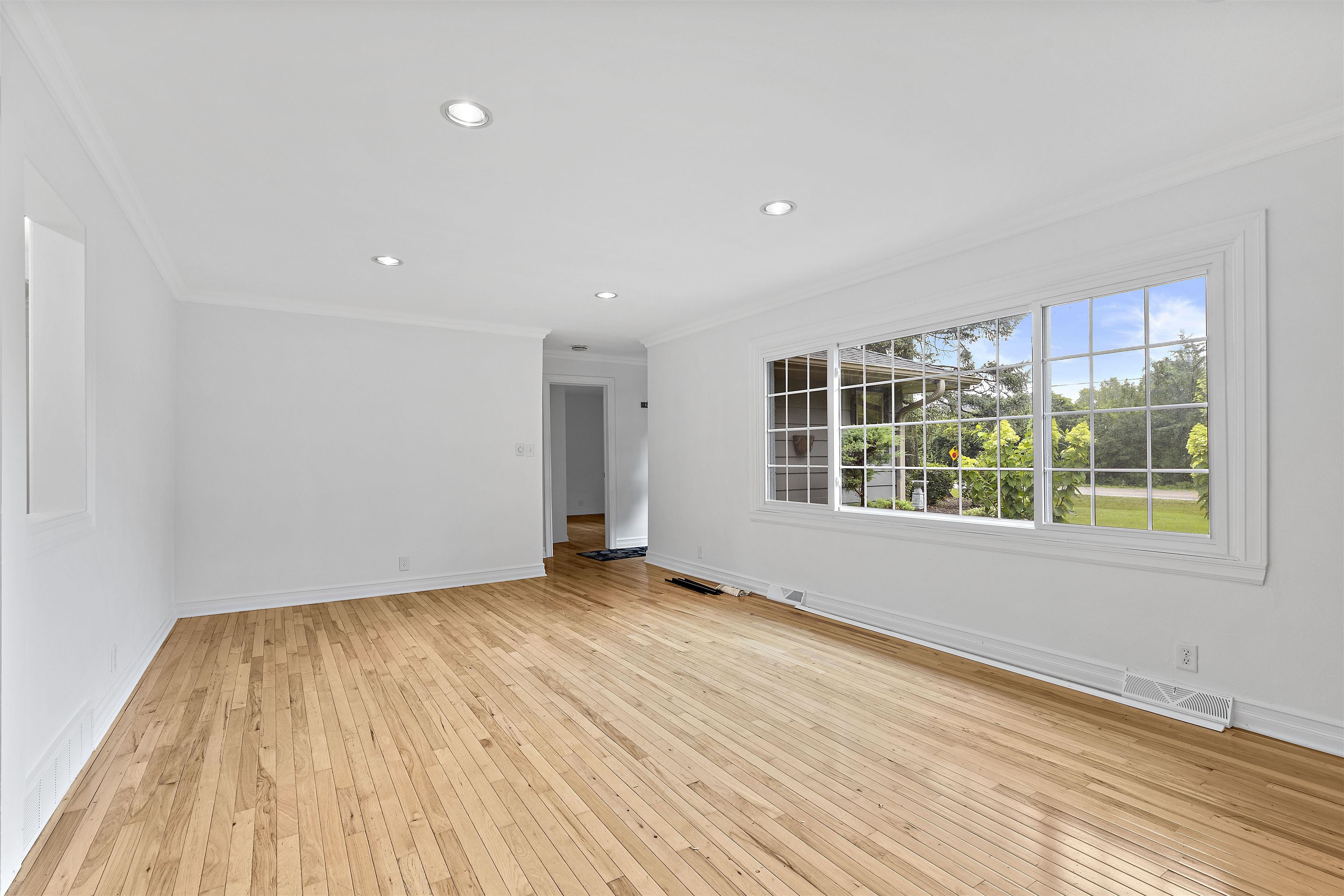 2906 Reid Farm Road Rockford, IL 61114 - Photo 4 of 18 a view of an empty room with wooden floor and a window