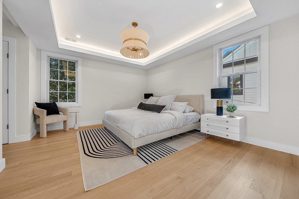 27 High Street, Unit 27 Newton, MA 02461 - Photo 22 of 39 a bedroom with a bed and wooden floor