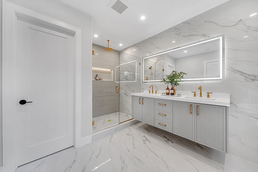 27 High Street, Unit 27 Newton, MA 02461 - Photo 24 of 39 a bathroom with a double vanity sink mirror and shower