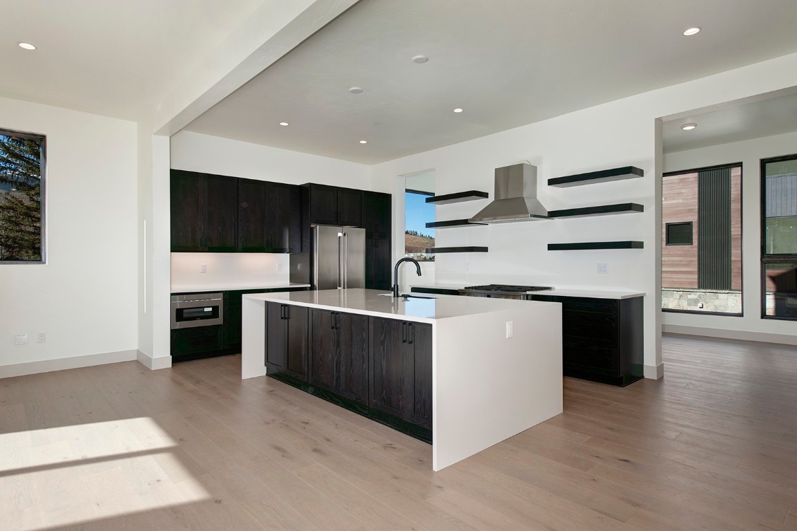 a kitchen with stainless steel appliances kitchen island wooden cabinets and granite counter tops
