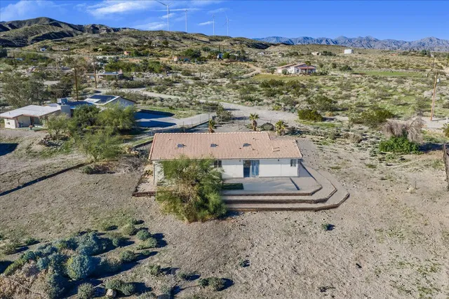 an aerial view of a house with a yard