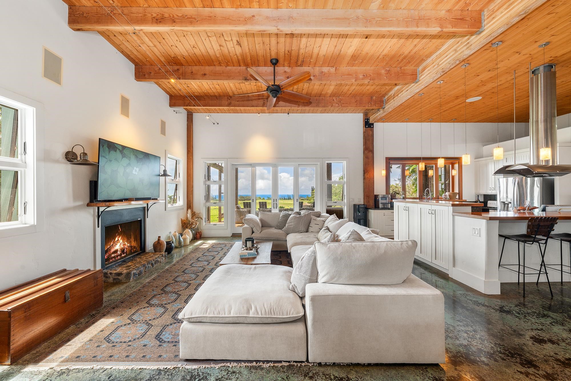 1949 West Kuiaha Road Haiku, HI 96708 - Photo 5 of 49 a living room with furniture a flat screen tv and a fireplace