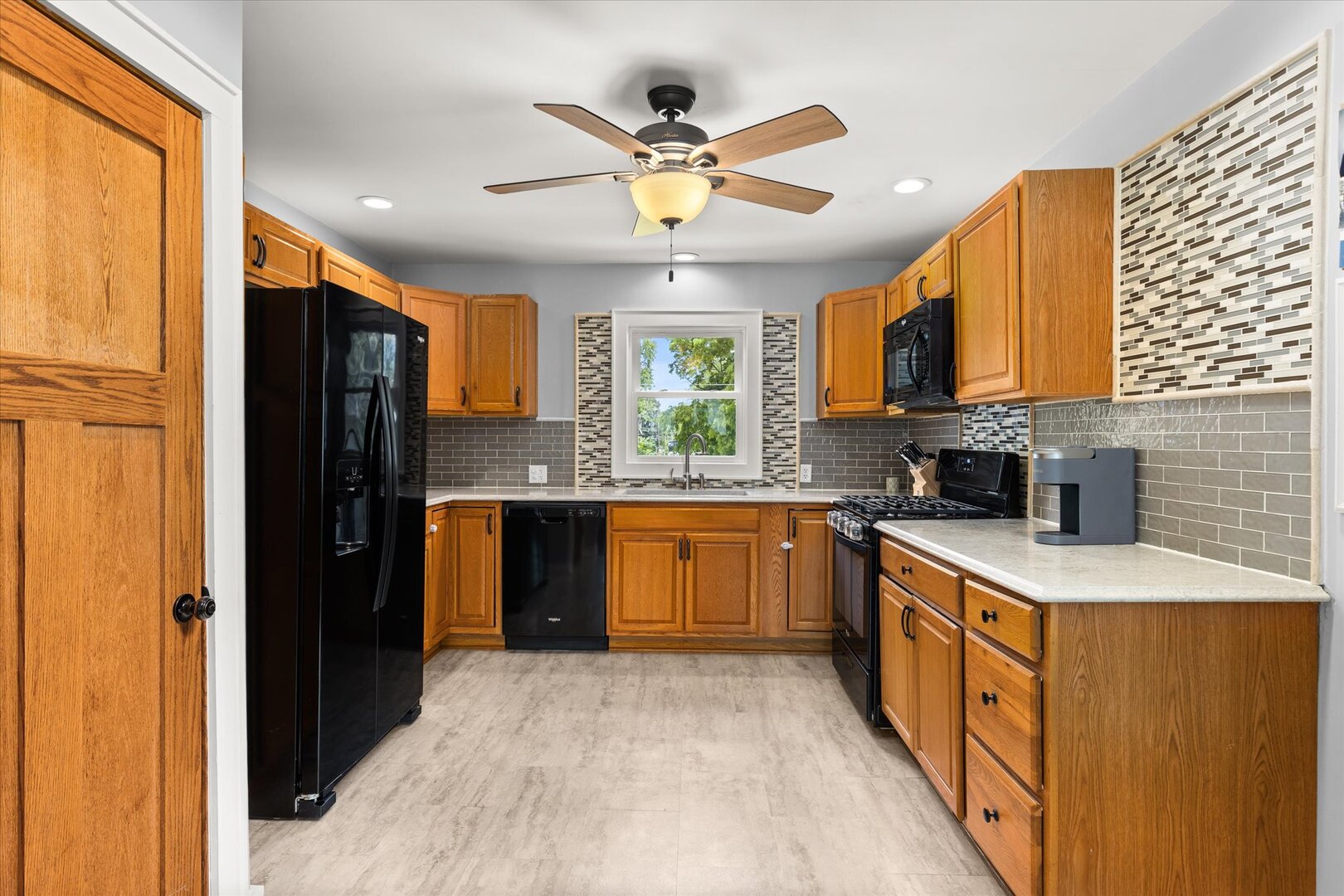 742 Chambers Street Ottawa, IL 61350 - Photo 14 of 39 a kitchen with stainless steel appliances granite countertop a refrigerator a sink dishwasher a stove and a dining table with wooden floor