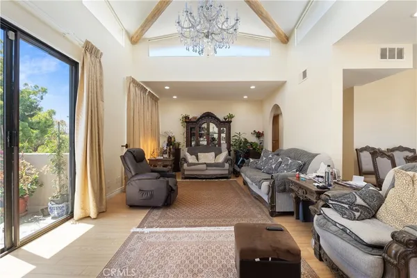 a living room with furniture and a chandelier