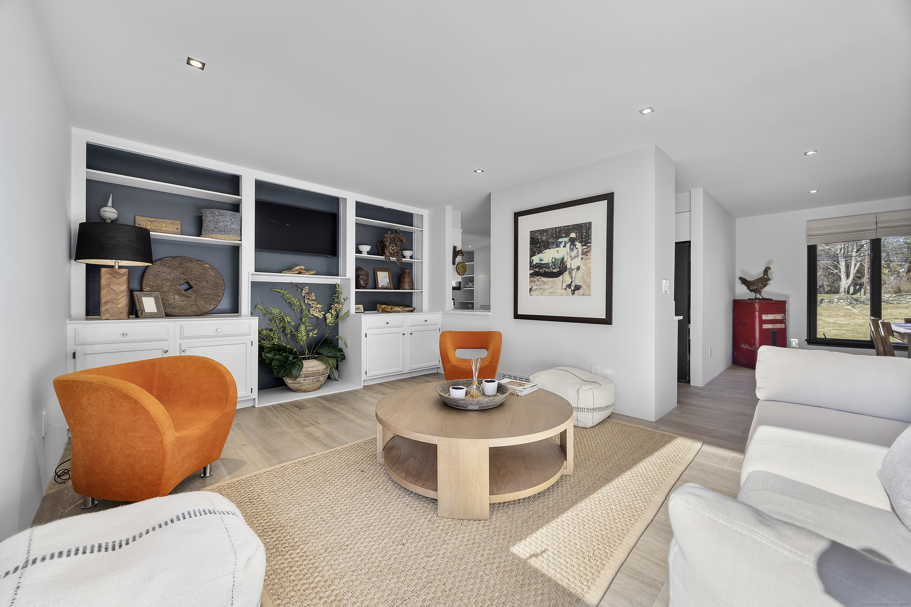 1001 Hulls Farm Road Fairfield, CT 06890 - Photo 11 of 40 a living room with furniture and a flat screen tv