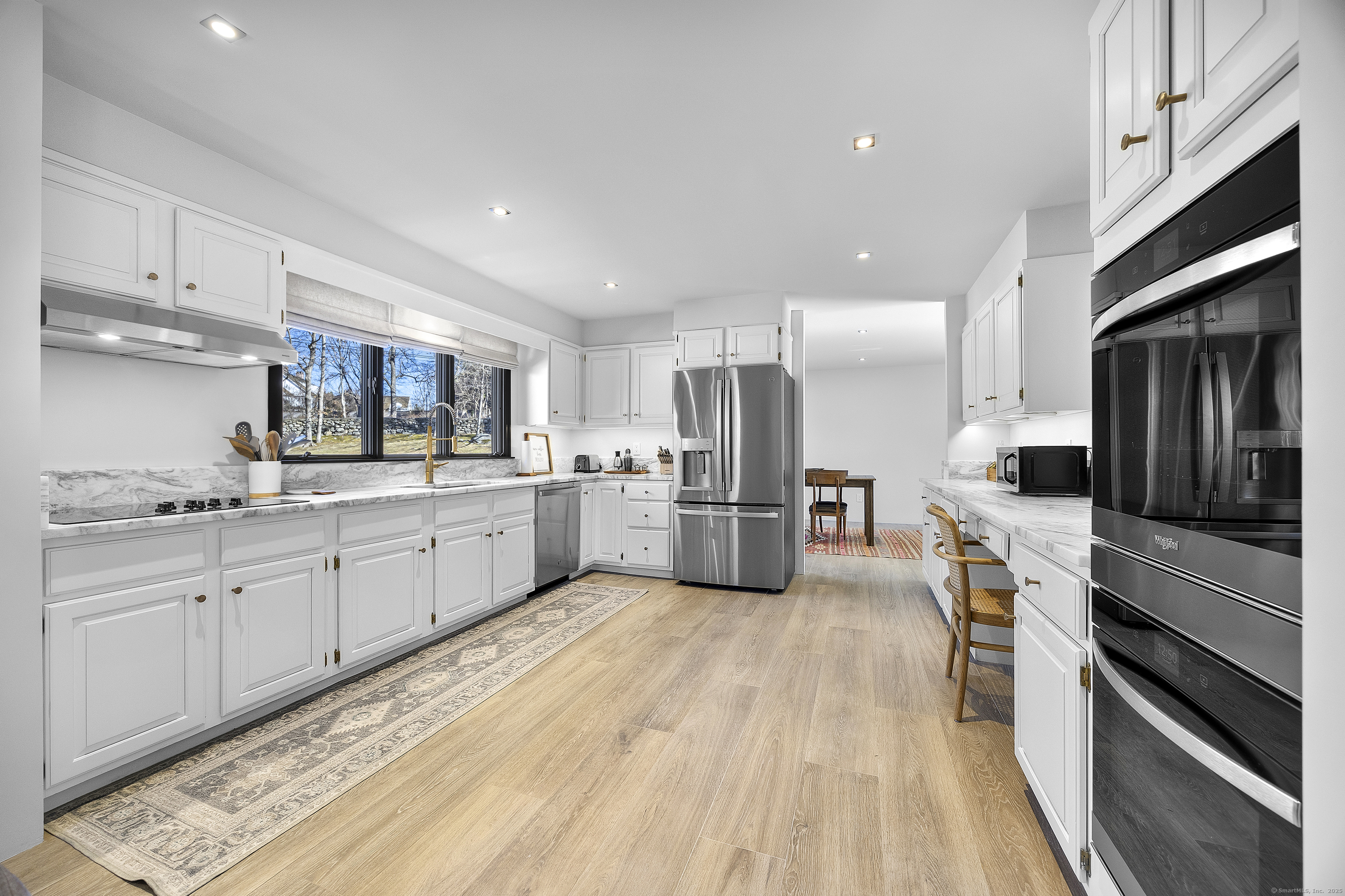 1001 Hulls Farm Road Fairfield, CT 06890 - Photo 17 of 40 a large kitchen with cabinets stainless steel appliances and a counter top