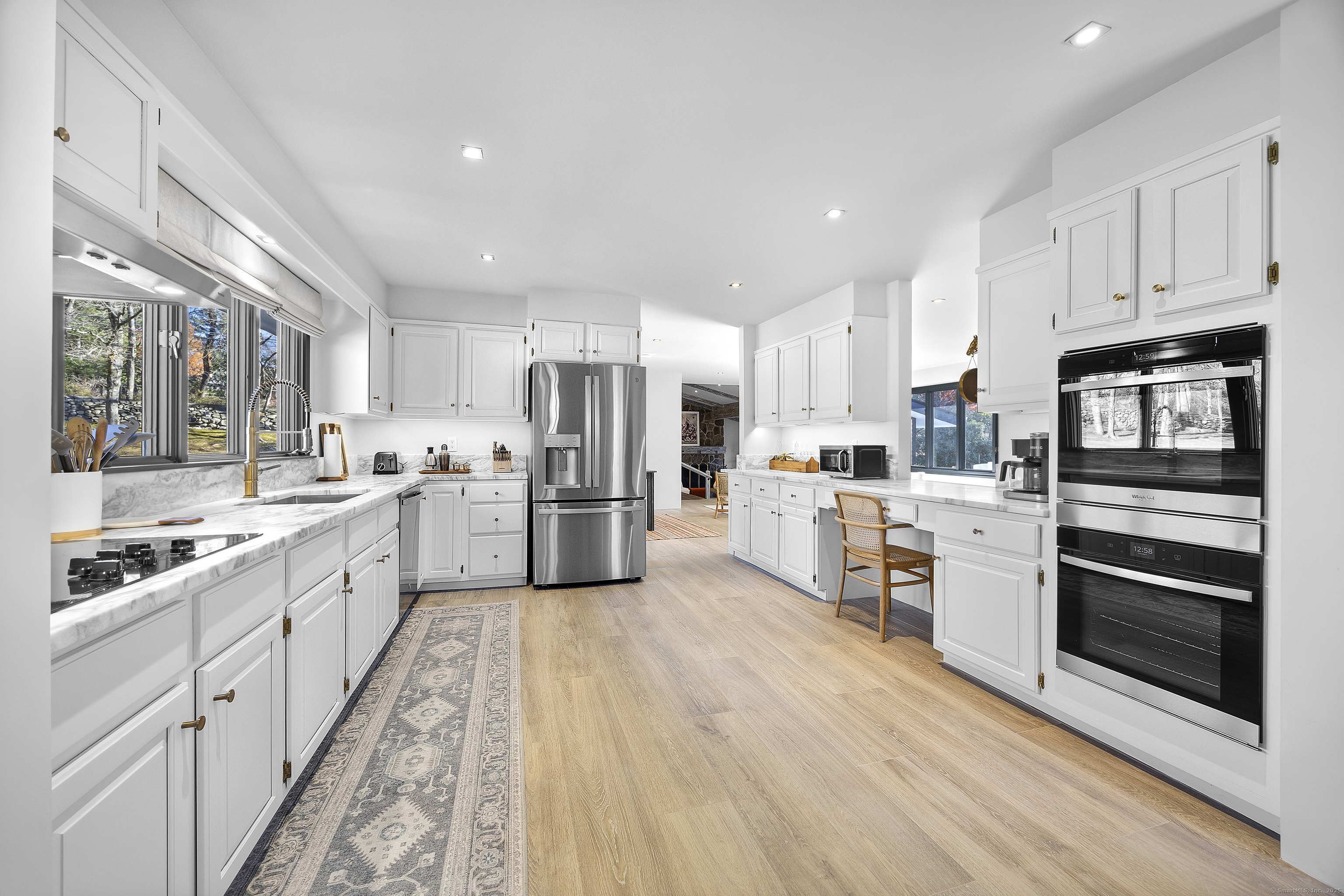 1001 Hulls Farm Road Fairfield, CT 06890 - Photo 18 of 40 a large kitchen with stainless steel appliances and white cabinets