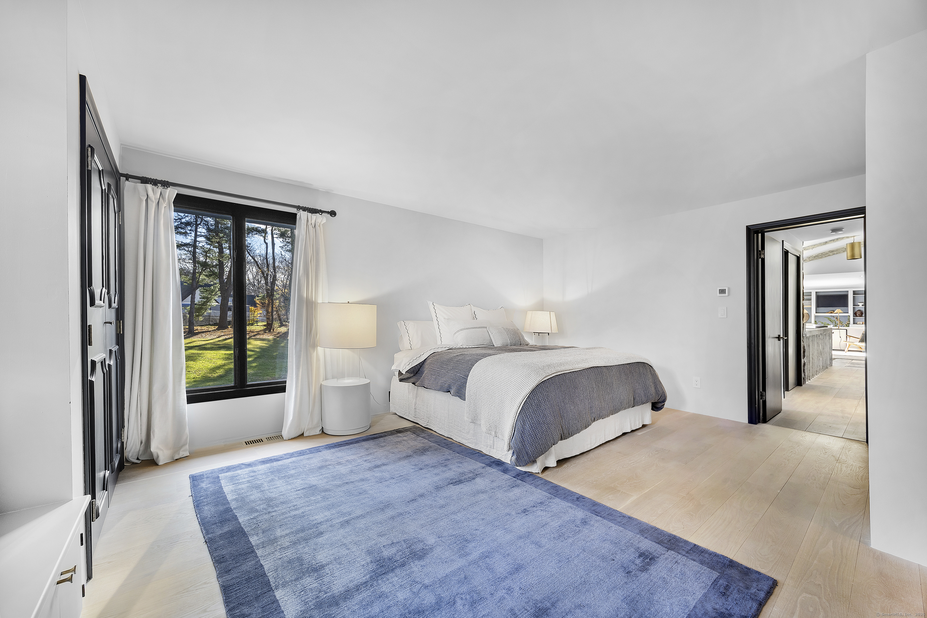 1001 Hulls Farm Road Fairfield, CT 06890 - Photo 20 of 40 a bedroom with a large bed and walk in closet