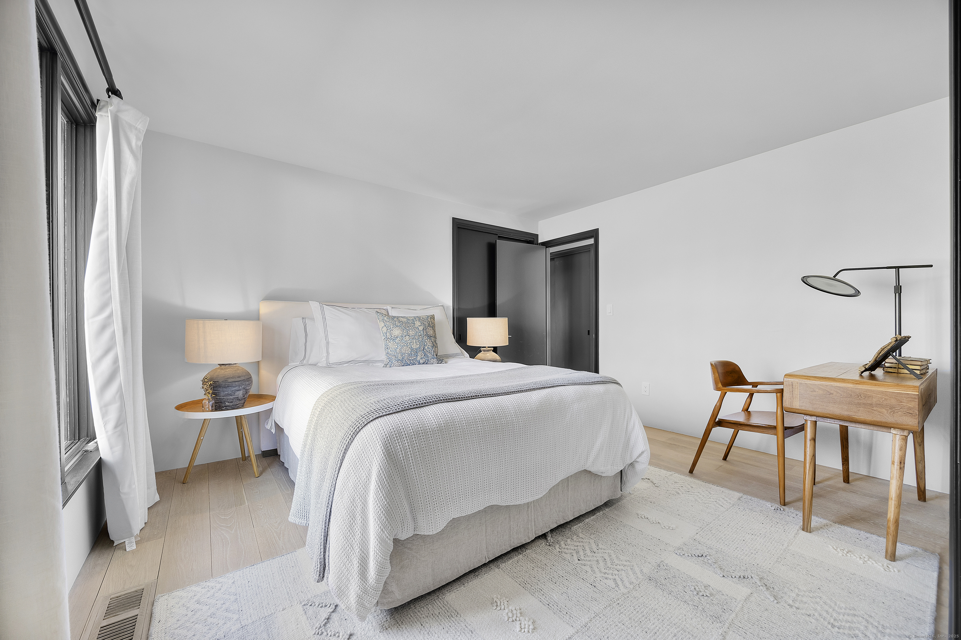 1001 Hulls Farm Road Fairfield, CT 06890 - Photo 26 of 40 a bedroom with a bed and a chair