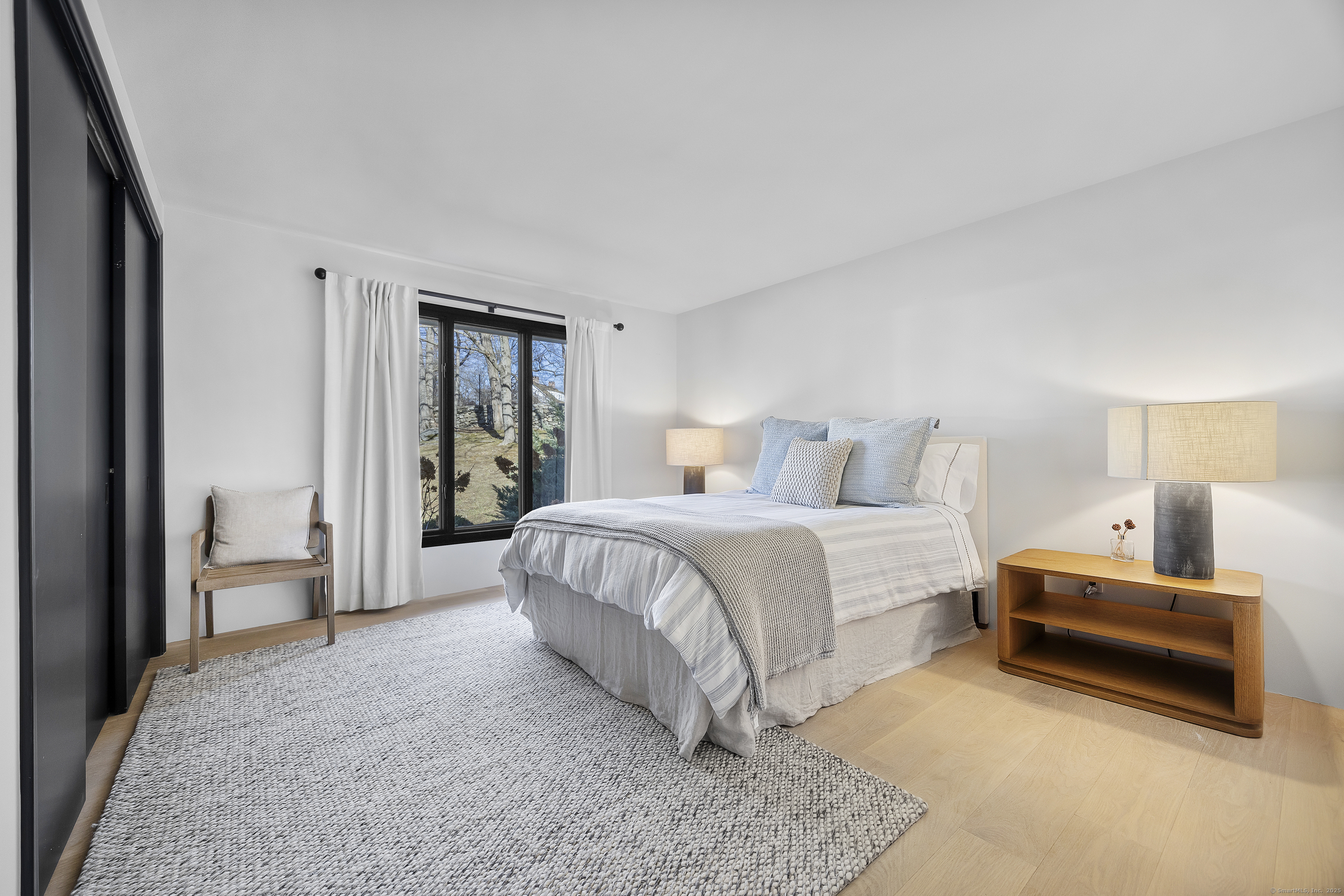 1001 Hulls Farm Road Fairfield, CT 06890 - Photo 27 of 40 a bedroom with a bed and a night stand