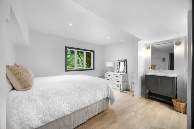 a bedroom with a large bed and a desk