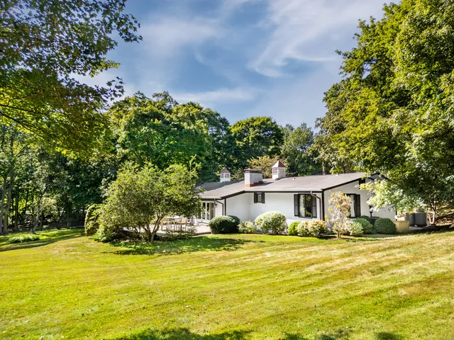 a front view of a house with a big yard