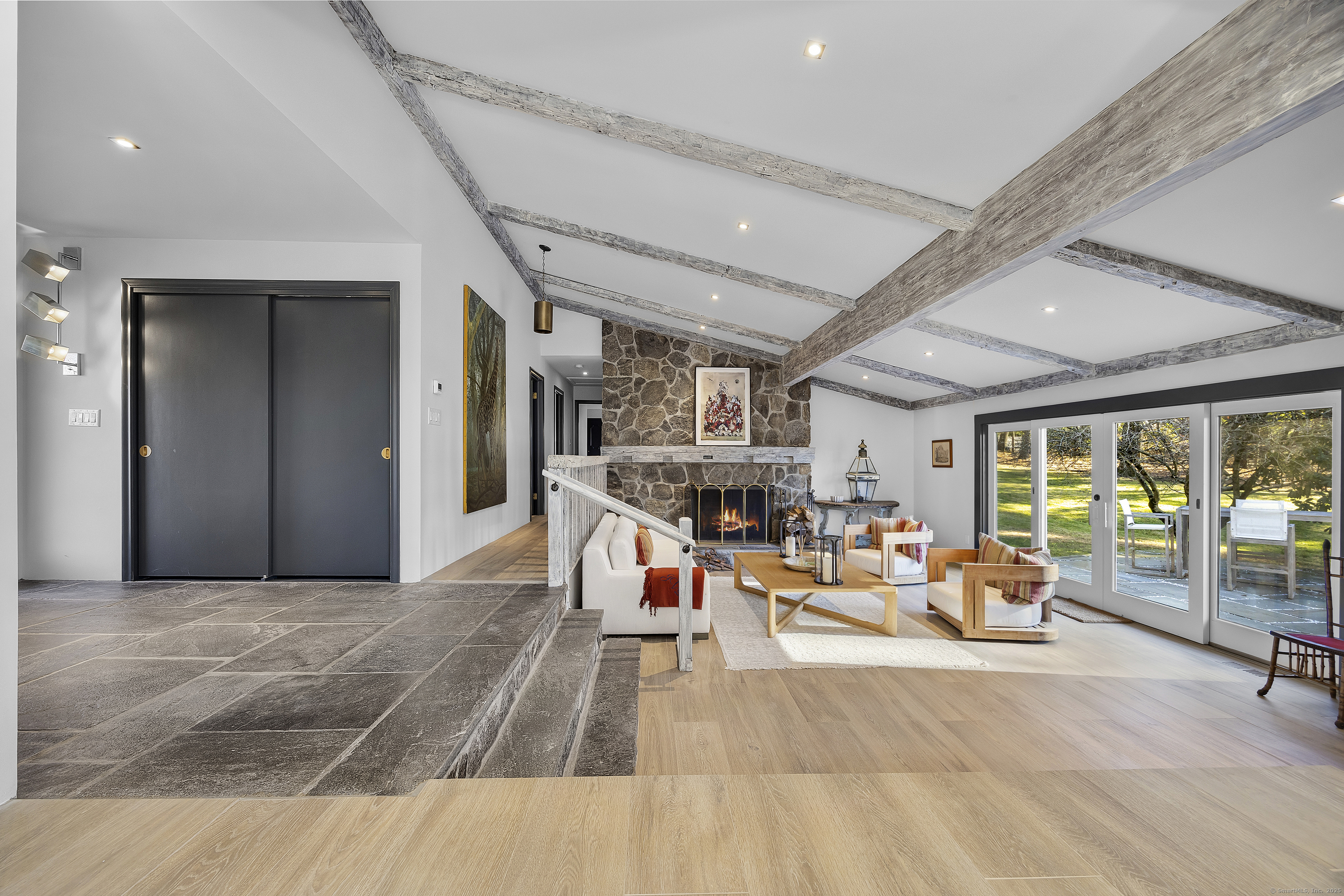 1001 Hulls Farm Road Fairfield, CT 06890 - Photo 4 of 40 a living room with furniture a fireplace and a large window