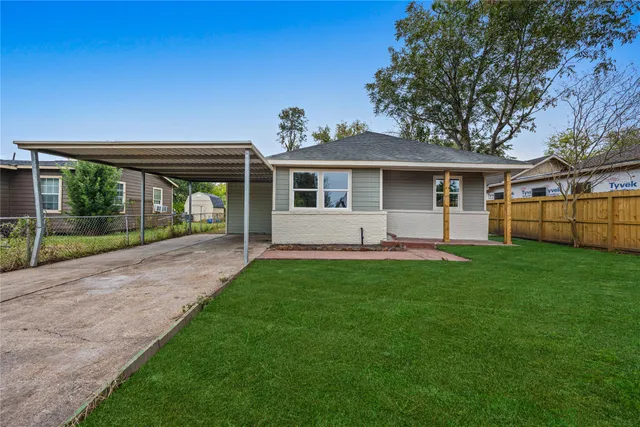 a view of a house with yard and a garden