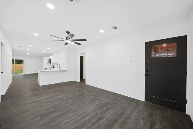 a view of a kitchen with a sink and a refrigerator