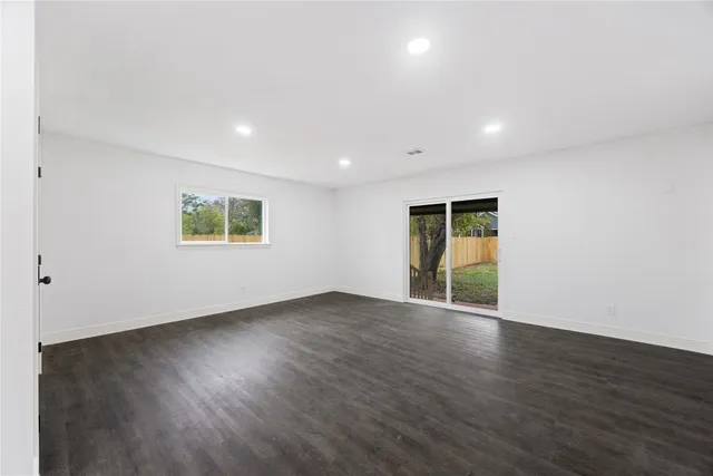 a view of a kitchen with a refrigerator and a sink