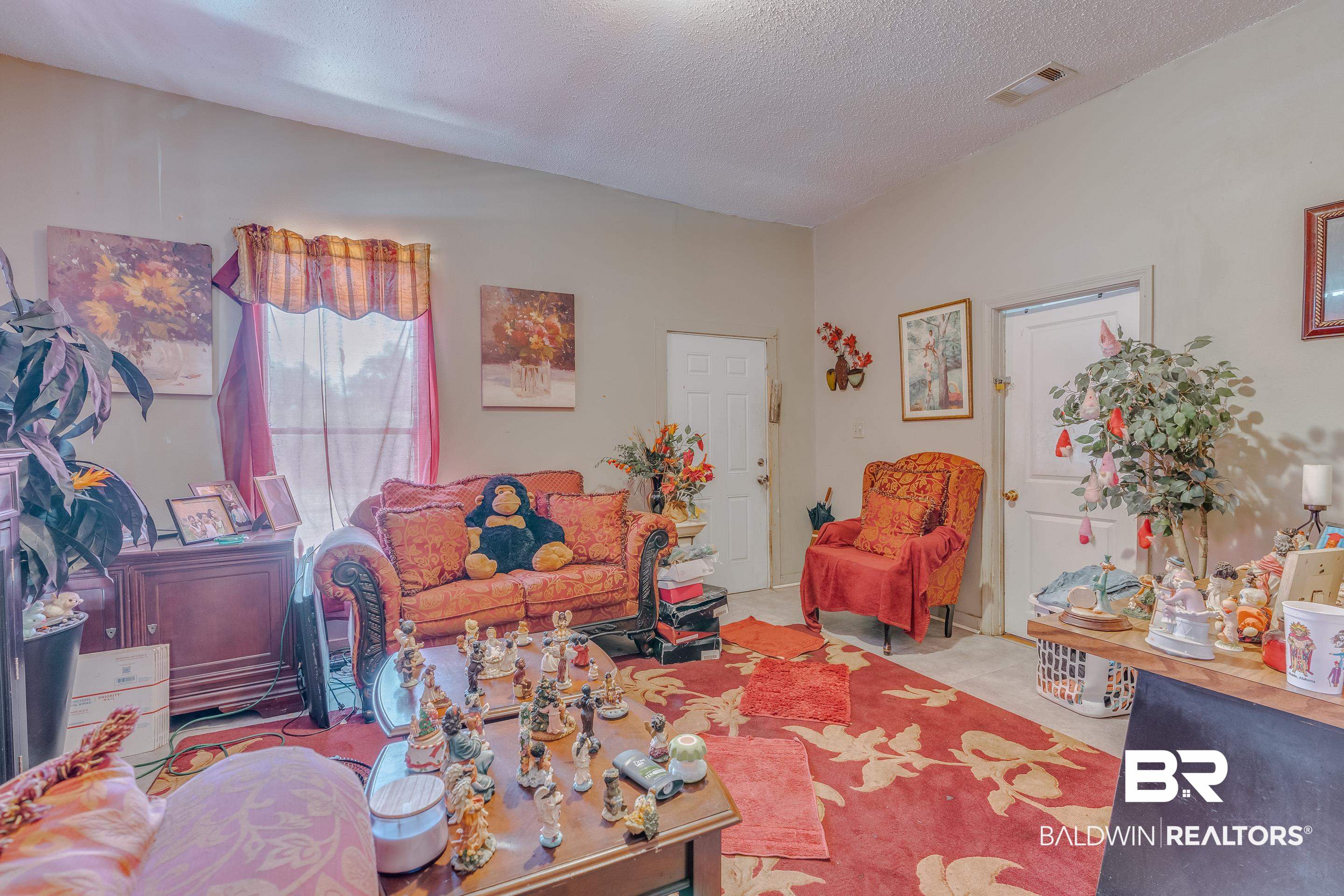 1156 Freeman Street Mobile, AL 36605 - Photo 18 of 22 Living area with a textured ceiling and visible vents