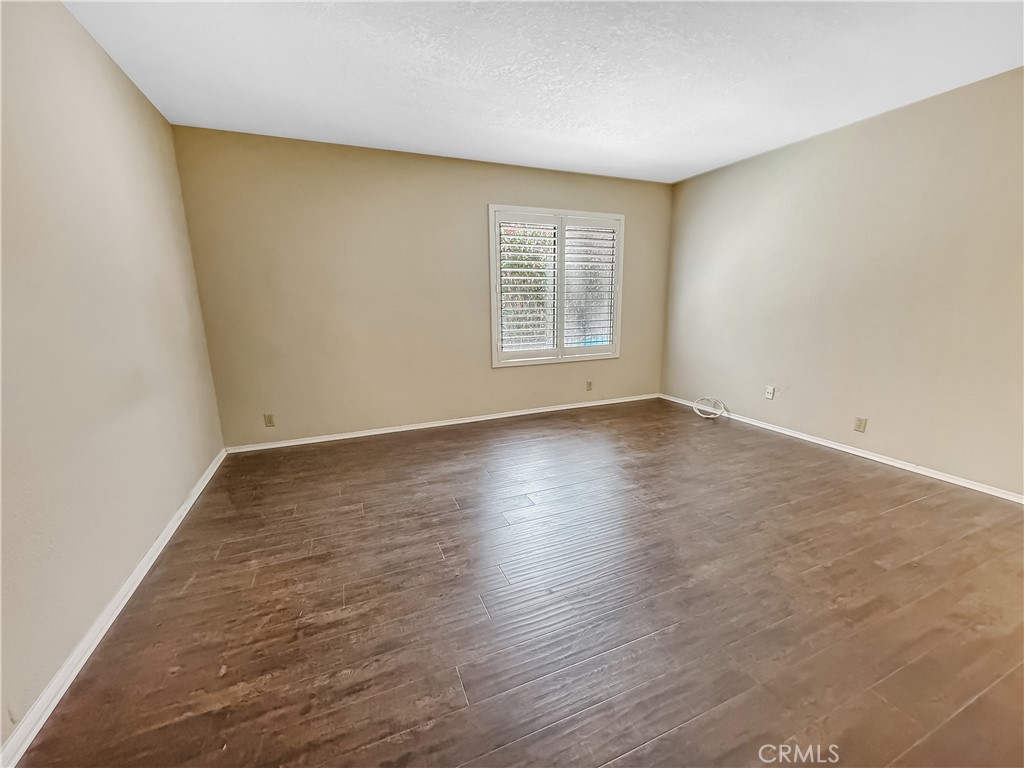 600 Central Avenue, Unit 323 Riverside, CA 92507 - Photo 12 of 25 an empty room with wooden floor and windows