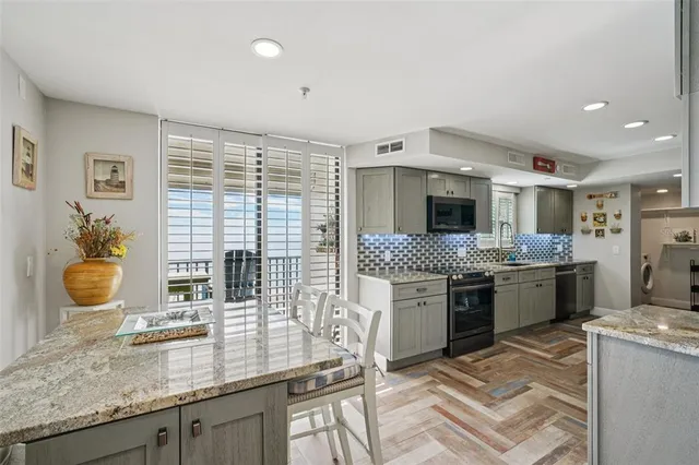 a kitchen with stainless steel appliances granite countertop a stove and a sink