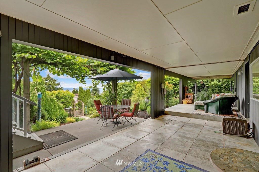 1031 C Avenue South Edmonds, WA 98020 - Photo 21 of 25 a view of a patio with table and chairs potted plants with floor to ceiling window